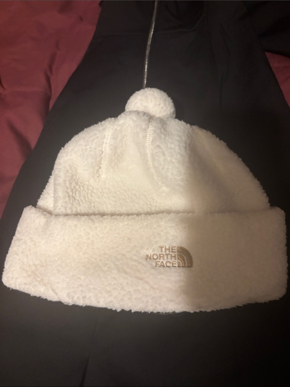 The North Face White Sherpa Pom Beanie with Gold Logo